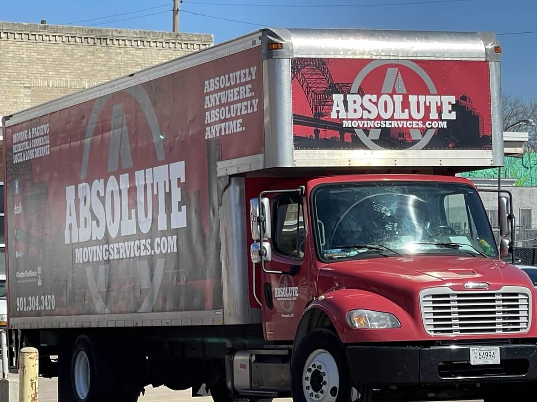 A red Absolute Moving Services truck